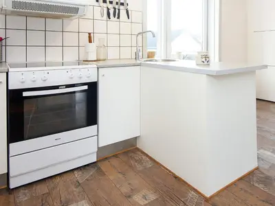 a white kitchen with a sink and a stove at 8 person holiday home in Thyborøn-By Traum in Thyborøn