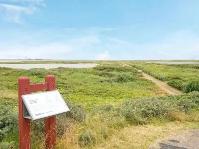 a sign on the side of a road in a field at 8 person holiday home in Thyborøn-By Traum in Thyborøn