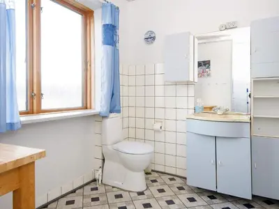 a bathroom with a toilet and a sink and a window at 8 person holiday home in Thyborøn-By Traum in Thyborøn