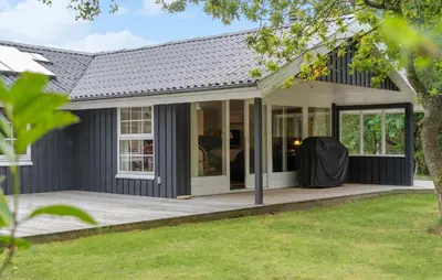an exterior view of a house with a porch at Cozy Home In Vestervig With Sauna in Vestervig