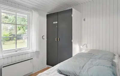a white bedroom with a bed and a window at Cozy Home In Vestervig With Sauna in Vestervig