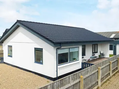 a white house with a black roof at 6 person holiday home in Thyborøn-By Traum in Thyborøn