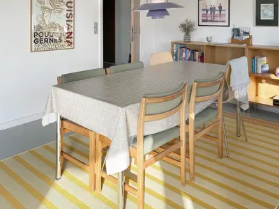 a dining room table with four chairs and a table at 6 person holiday home in Thyborøn-By Traum in Thyborøn