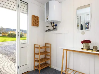 a kitchen with a counter and a shelf and a door at 8 person holiday home in Lemvig-By Traum in Lemvig