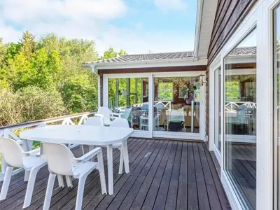 a white table and chairs on a deck at 6 person holiday home in Løgstør-By Traum in Løgstør