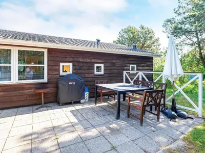 a patio with a table and chairs in front of a house at 6 person holiday home in Løgstør-By Traum in Løgstør