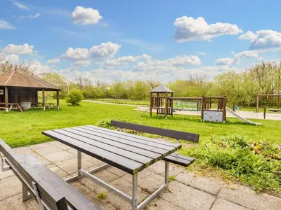 a park with a picnic table and a playground at 7 person holiday home in Vestervig-By Traum in Vestervig