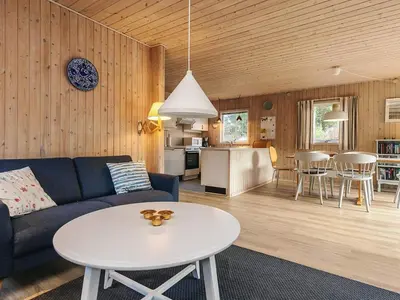 a living room with a couch and a table at 6 person holiday home in Fjerritslev in Fjerritslev