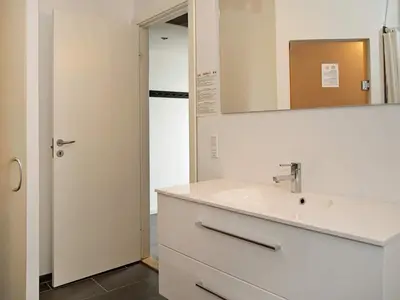 a bathroom with a sink and a mirror at 8 person holiday home in Ulfborg-By Traum in Ulfborg