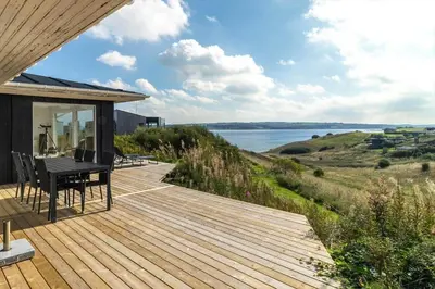 a wooden deck with a view of the water at G182-Lemvig-Bellisvej-82 in Lemvig
