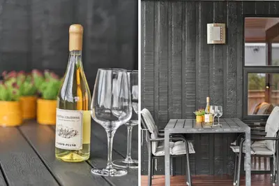 a bottle of wine sitting on a table with a wine glass at 813-Harboore-Neerlandiavej-136 in Harboør