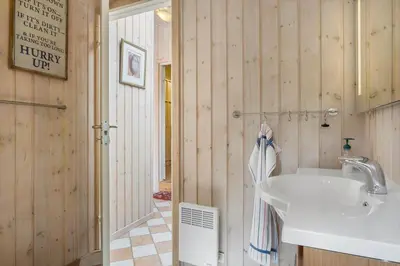 a bathroom with a white sink and a mirror at BL1112-Saltum-Graabakken-26 in Saltum