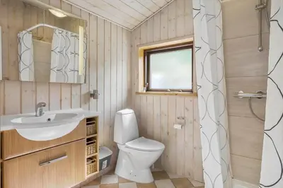 a bathroom with a sink and a toilet and a window at BL1112-Saltum-Graabakken-26 in Saltum
