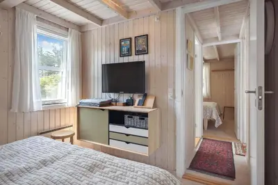 a bedroom with a bed and a flat screen tv at BL1113-Saltum-Revlingevej-26 in Saltum