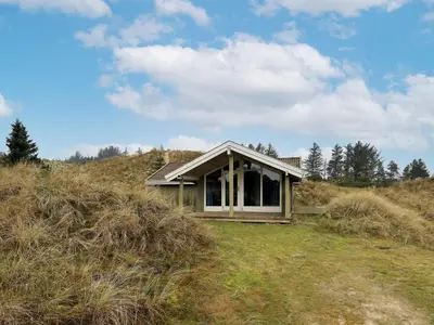 a small house on a hill in a field at Spacious Retreat with Views - By Traum Ferienwohnungen in Blokhus