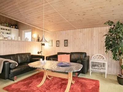 a living room with a couch and a table at Spacious Retreat with Views - By Traum Ferienwohnungen in Blokhus