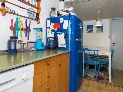 a blue refrigerator in a kitchen with a table at 5 person holiday home in Thyborøn in Thyborøn