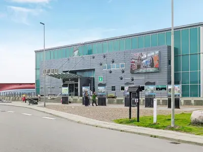 a building with people standing outside of it on a street at 5 person holiday home in Thyborøn in Thyborøn