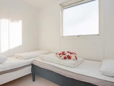 two beds in a room with a window at 6 person holiday home in Lemvig in Lemvig