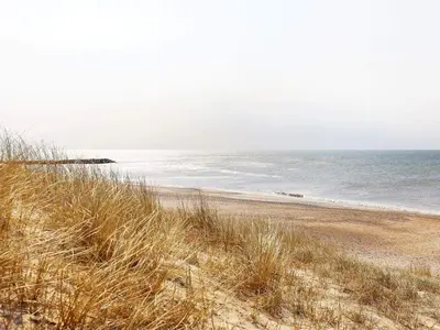 a sandy beach with a view of the ocean at 6 person holiday home in Lemvig in Lemvig