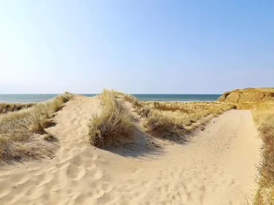 a dirt road leading to the ocean on a beach at 6 person holiday home in Lemvig in Lemvig