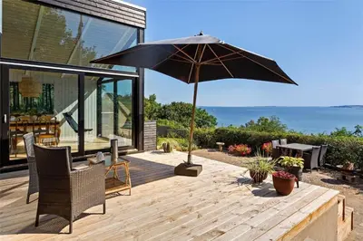 a patio with an umbrella and a table and chairs at LF473-Thisted-Asvej-73 in Thisted