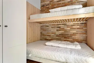 a bedroom with two bunk beds and a brick wall at LF473-Thisted-Asvej-73 in Thisted