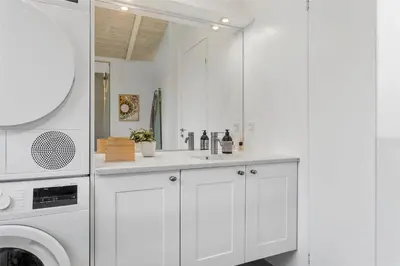 a white kitchen with a sink and a washing machine at LF473-Thisted-Asvej-73 in Thisted