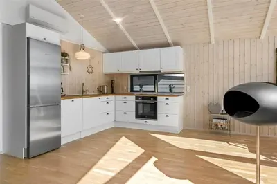 a kitchen with white cabinets and a stainless steel refrigerator at LF473-Thisted-Asvej-73 in Thisted