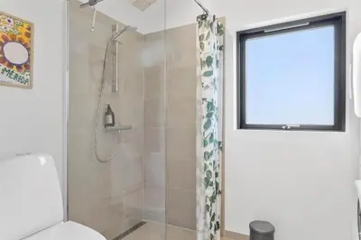 a bathroom with a shower with a toilet and a window at LF473-Thisted-Asvej-73 in Thisted
