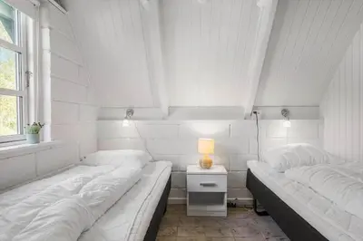 two beds in a white room with a window at LF14258-Fur-Marehalmvej-8 in Fur