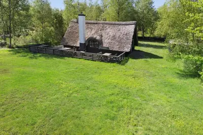 an old house with a thatch roof in a field at LF14258-Fur-Marehalmvej-8 in Fur