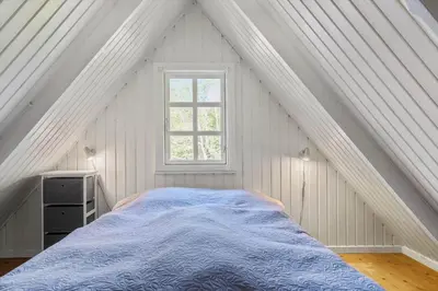 a bed in a white room with a window at LF14258-Fur-Marehalmvej-8 in Fur