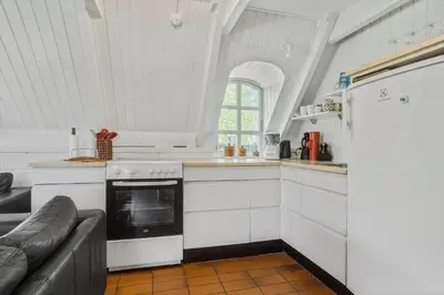 a kitchen with a stove and a couch in a room at LF14258-Fur-Marehalmvej-8 in Fur