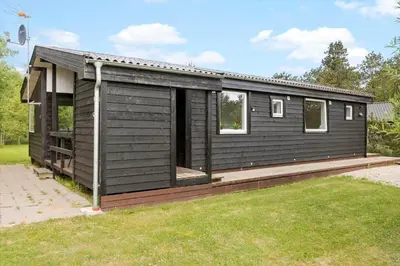 a black house with a porch and a yard at LF10320-Hurup-Thy-Nattergalevej-2-B in Sønder Ydby