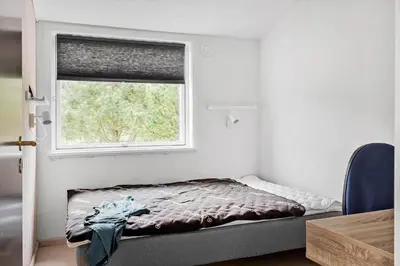 a small bedroom with a bed and a window at LF10320-Hurup-Thy-Nattergalevej-2-B in Sønder Ydby