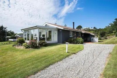 a small house on a hill with a gravel driveway at LF11731-Struer-Skraningen-31 in Struer