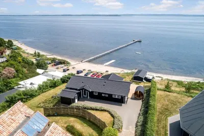 an aerial view of a house next to the ocean at LF14194-Roslev-Bagvejen-26 in Roslev
