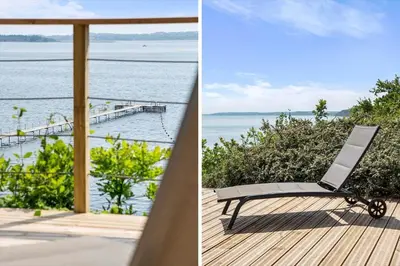 a chair on a deck with a view of the water at LF14194-Roslev-Bagvejen-26 in Roslev
