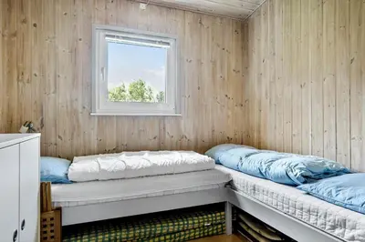 a room with two bunk beds and a window at LF101-Vestervig-Hellesvej-1 in Vestervig