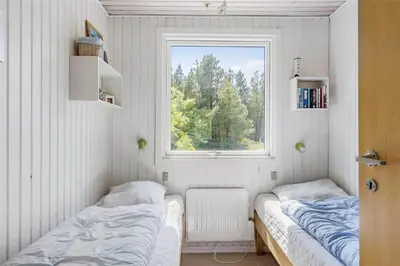 two beds in a small room with a window at LF10236-Thyholm-Svinget-18 in Thyholm