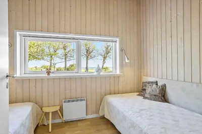 a bedroom with two beds and a window at LF14038-Roslev-Stranddalen-119 in Roslev