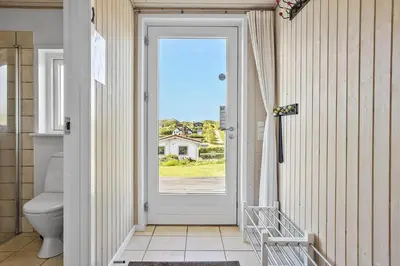 a bathroom with a door leading to a toilet at LF14038-Roslev-Stranddalen-119 in Roslev