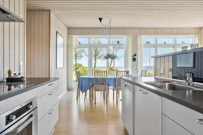 a kitchen with a table with a blue table cloth at LF14038-Roslev-Stranddalen-119 in Roslev