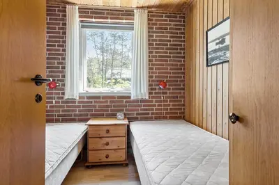 a room with two beds and a window at LF10314-Hurup-Thy-Edderfuglevej-15 in Sindrup