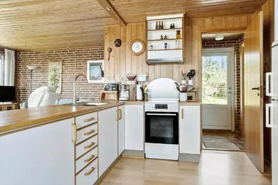 a kitchen with white cabinets and a stove top oven at LF10314-Hurup-Thy-Edderfuglevej-15 in Sindrup