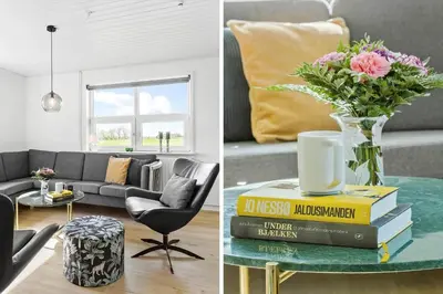 a living room with a couch and a table with a vase of flowers at LF14145-Spottrup-Uglkaeret-5 in Spottrup