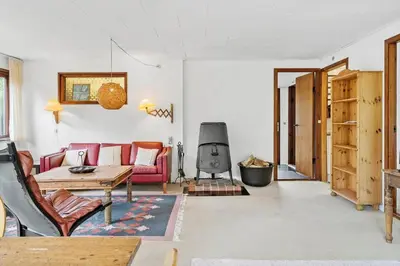 a living room with a couch and a table at LF10213-Thyholm-Haervej-9-B in Thyholm