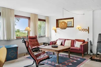 a living room with a couch and a table at LF10213-Thyholm-Haervej-9-B in Thyholm