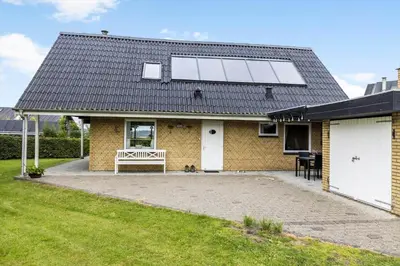 a house with a solar panel on the roof at LF14127-Roslev-Kybehuse-127 in Roslev